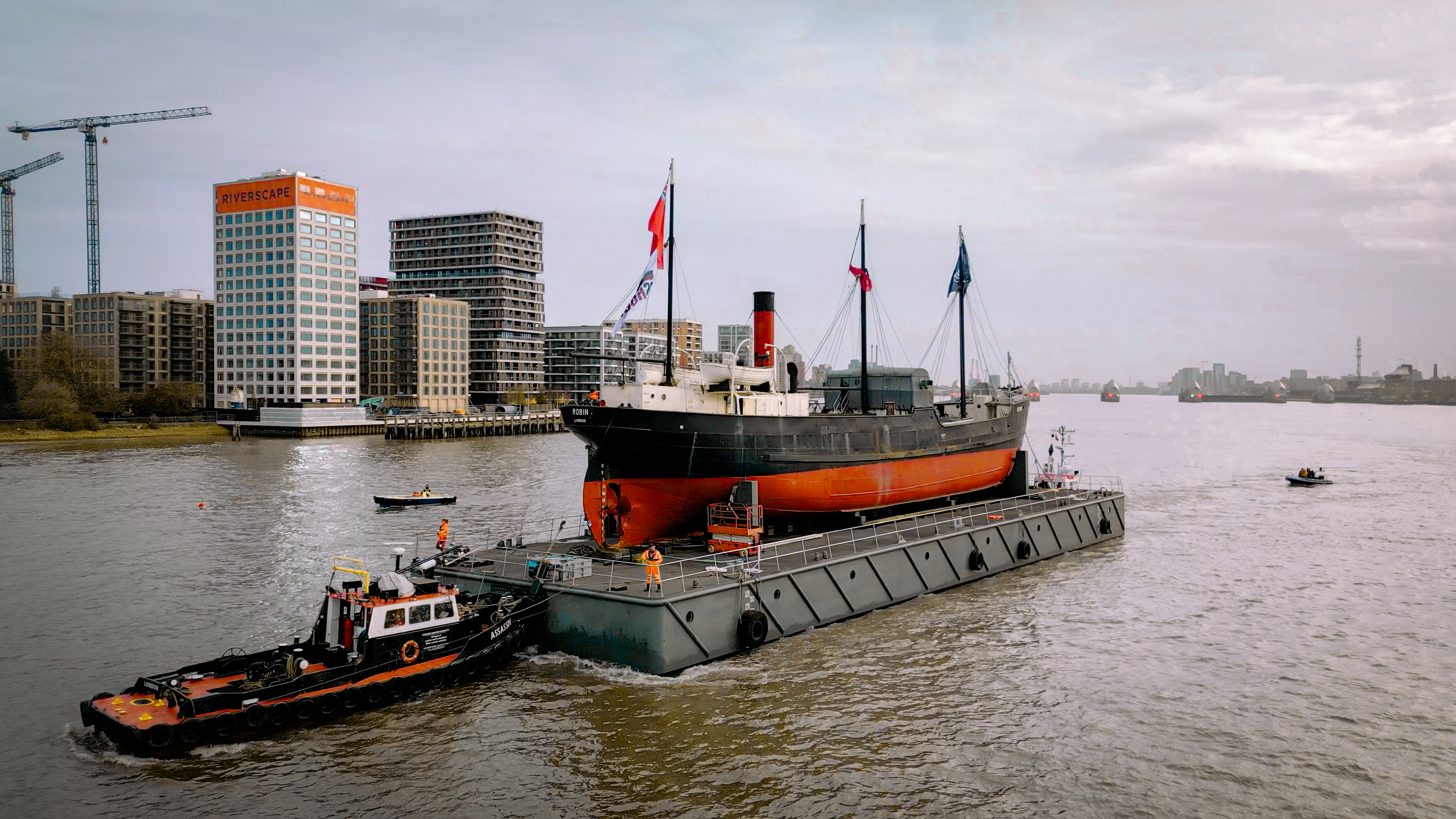Steamship SS Robin being transported on the Thames to her new home