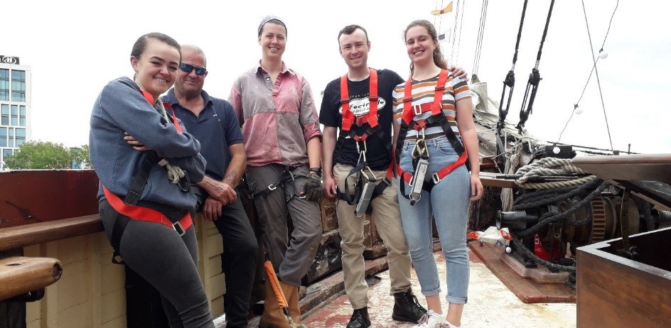 Volunteer on board assisting with rigging servicing