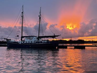 Michaela moored to pontoon with sunset in background