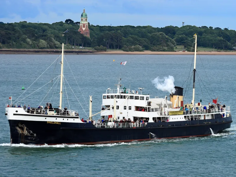SS Shieldhall signals MS Queen Victoria in front of the Royal Victoria Country Park by John Sanders