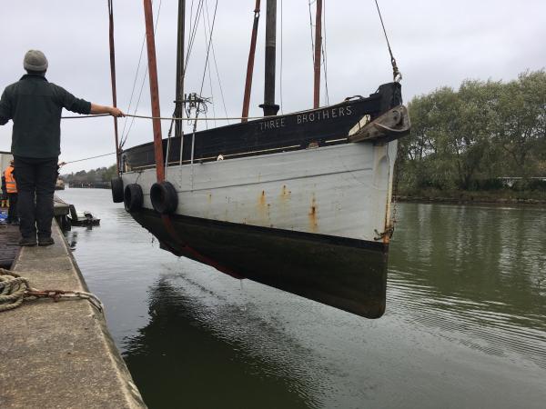 Three Brothers being lifted off the water