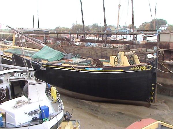 Edme alongside with her mast down