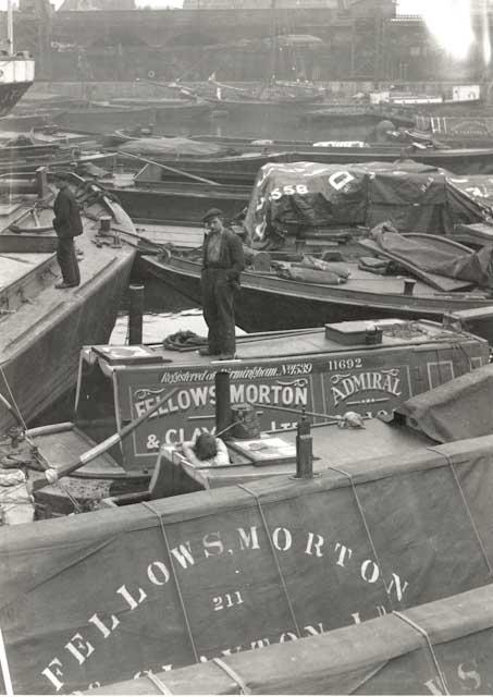 ADMIRAL amidst working barges