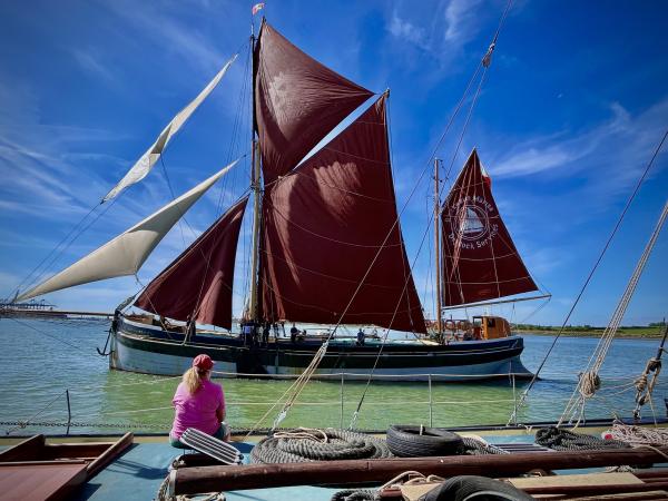 Red sails of promise: a beacon in azure skies