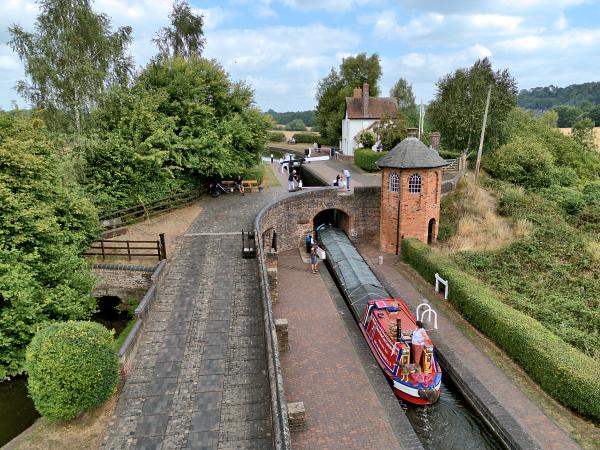 Narrow boat Corolla against the rural backdrop of the Staffordshire & Worcestershire Canal at Bratch Locks.