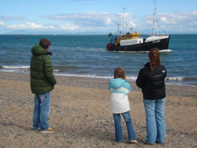 Watching the family fishing vessel