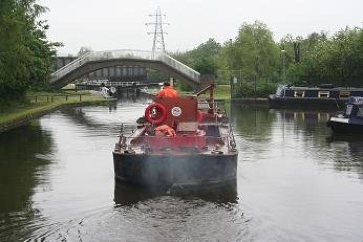 Enterprise going under a bridge - stern view