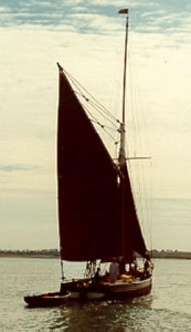 DORIS - under sail with tender in tow. Stern from starbaord quarter looking forward.