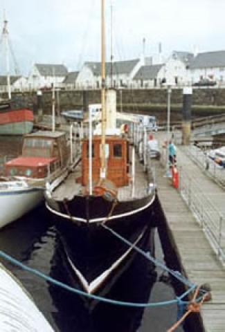 Photo of SY Carola moored at the pontoon at the Scottish Maritime Museum. Taken from bow looking along deck to stern. Ref: 1995/9/3/24