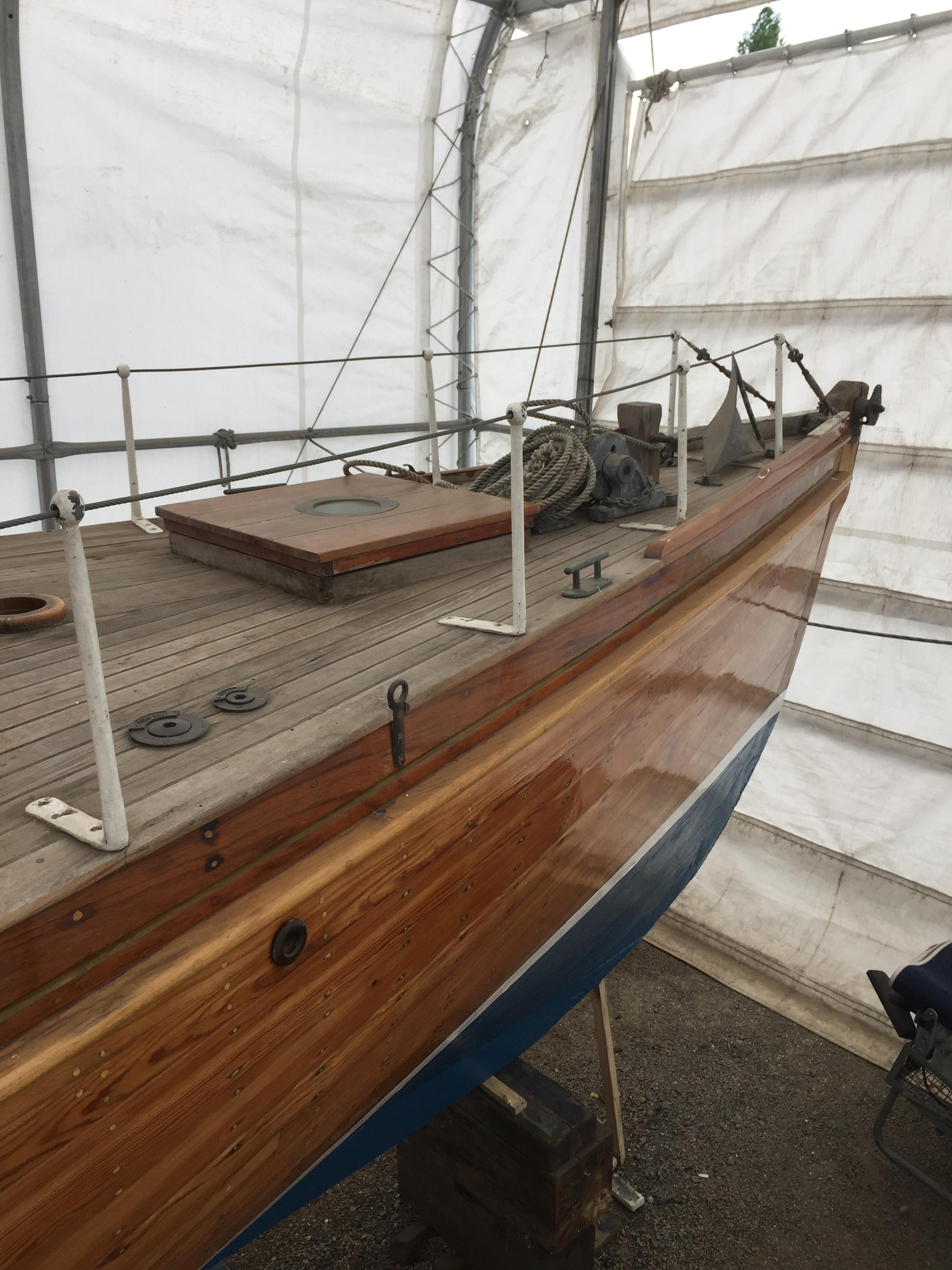 Sgur Urain hauled out at Bray Marina in 2026, showing her structurally exposed carvel hull and open framing prior to transit. 