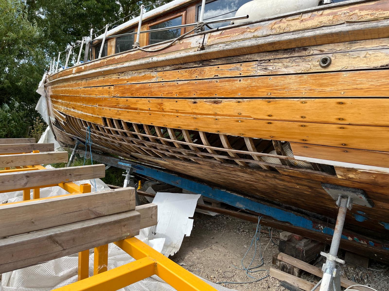 Sgur Urain hauled out at Bray Marina in 2026, showing her structurally exposed carvel hull and open framing prior to transit. 