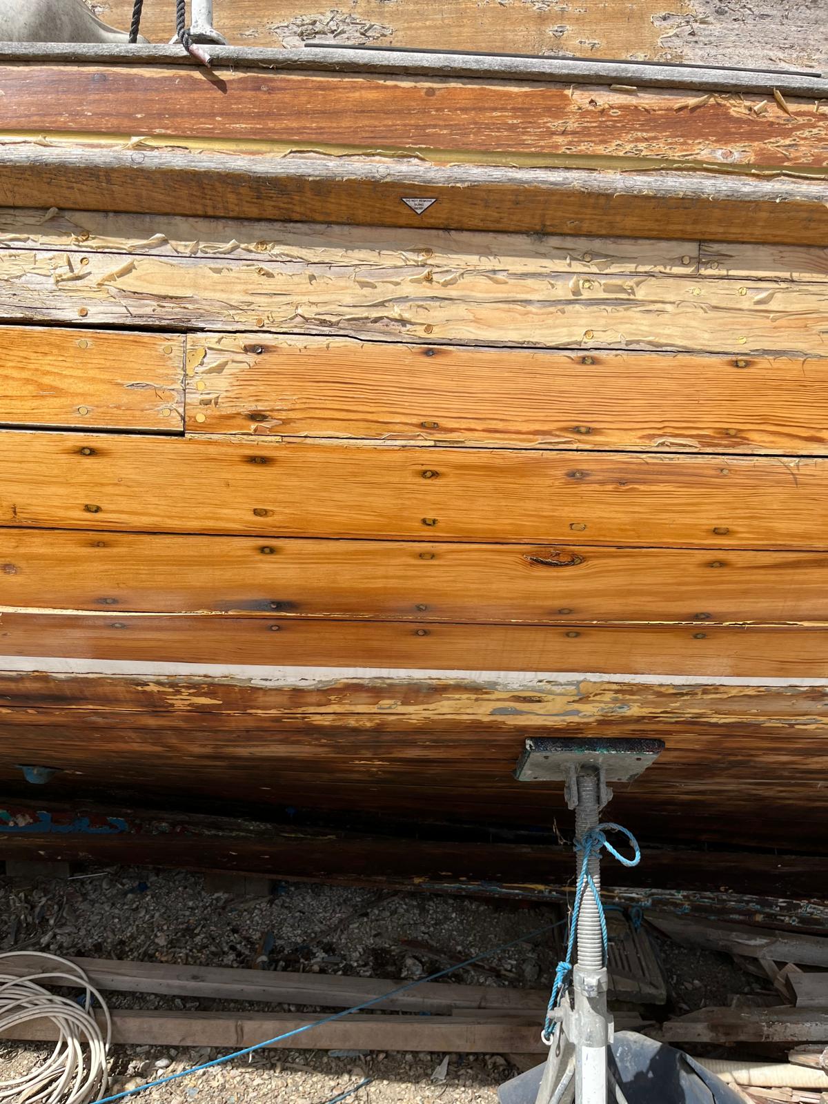 Sgur Urain hauled out at Bray Marina in 2026, showing her structurally exposed carvel hull and open framing prior to transit. 