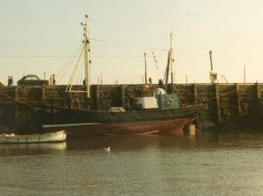 Faith moored and beached in low tide